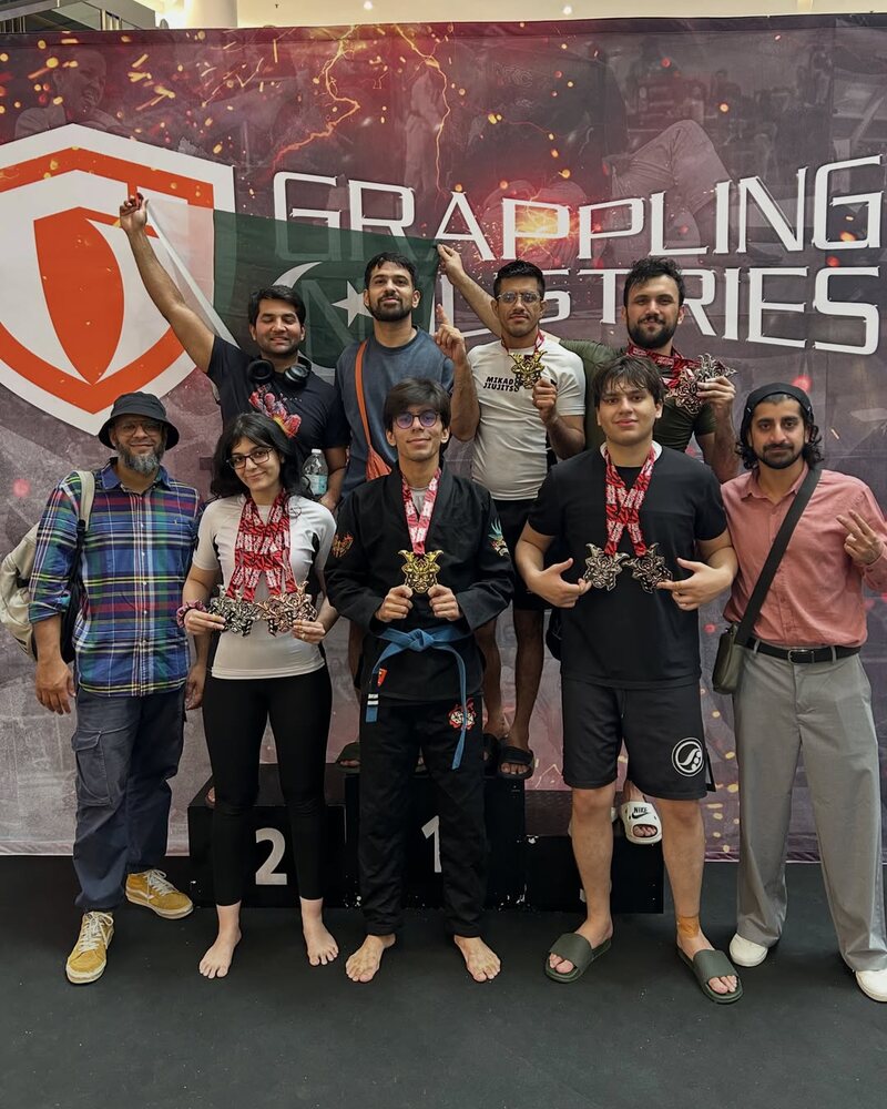 The Mikado team with their medals in front of the Grappling Industries banner